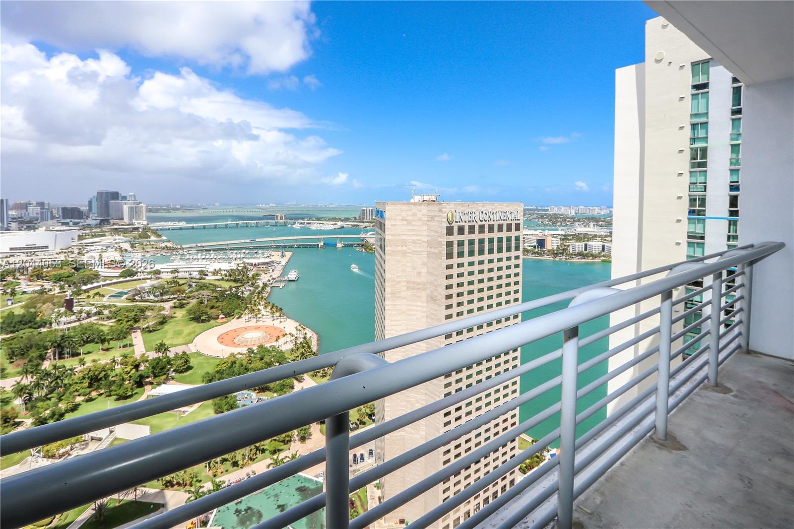 A high-rise balcony overlooks a park, a bay, and the InterContinental hotel in Miami — 325 S Biscayne Blvd # 3616, Miami FL 33131, MIAMI, FL