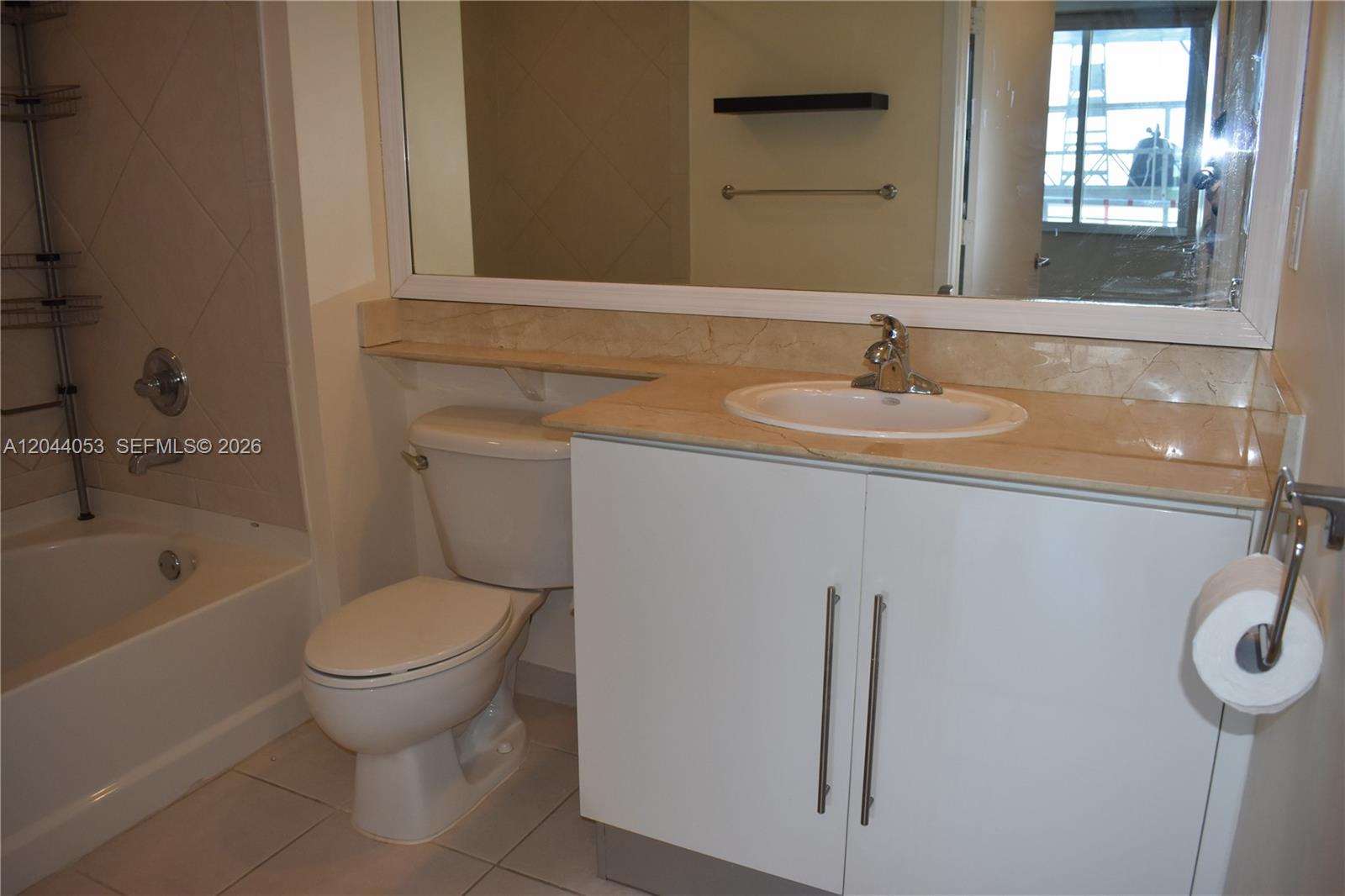 A bathroom features a white vanity, a beige countertop, a toilet, and a bathtub — 325 S Biscayne Blvd # 3616, Miami FL 33131, MIAMI, FL