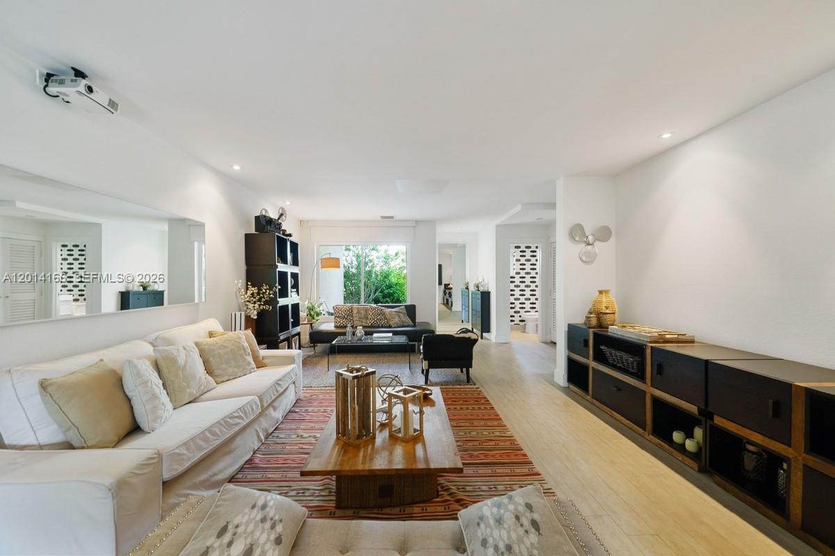 A bright living room features a white sofa, wooden coffee table, and dark storage units — 232 Sea View Dr # 108, Key Biscayne FL 33149, KEY BISCAYNE, FL