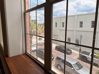 A view from a window looking down at a brick street with parked cars — 44 S MAGNOLIA AVENUE, OCALA, FL