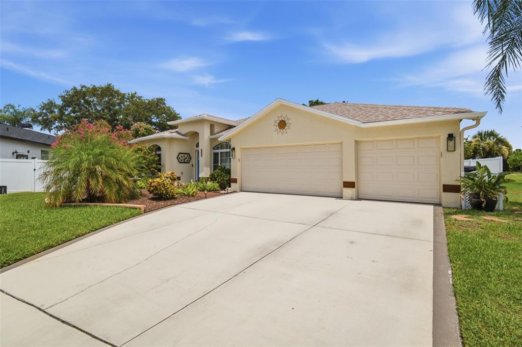 A single-story house with a two-car garage, light stucco exterior, and a concrete driveway — 11201 SAINT ANDREWS COURT, RIVERVIEW, FL