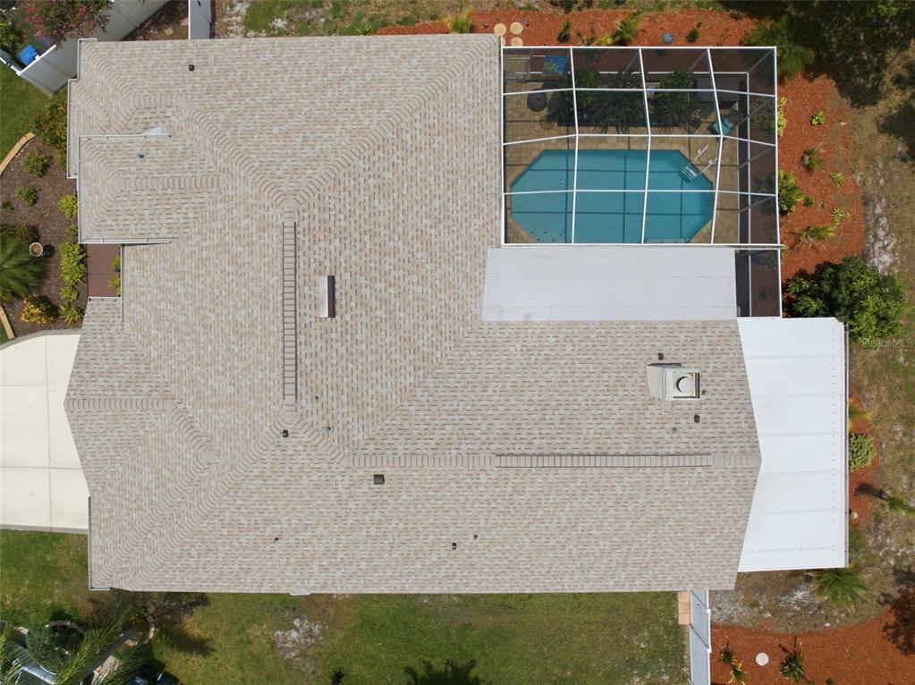 An aerial view shows a house roof with a screened-in pool and a white patio cover — 11201 SAINT ANDREWS COURT, RIVERVIEW, FL