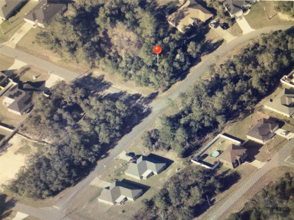 An aerial view shows a wooded residential lot marked with a red pin — 0 SW 29 CIRCLE, OCALA, FL