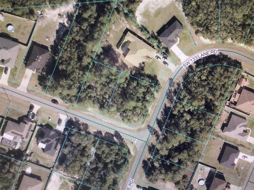 This is an aerial view of a residential neighborhood showing houses and wooded lots — 0 SW 29 CIRCLE, OCALA, FL