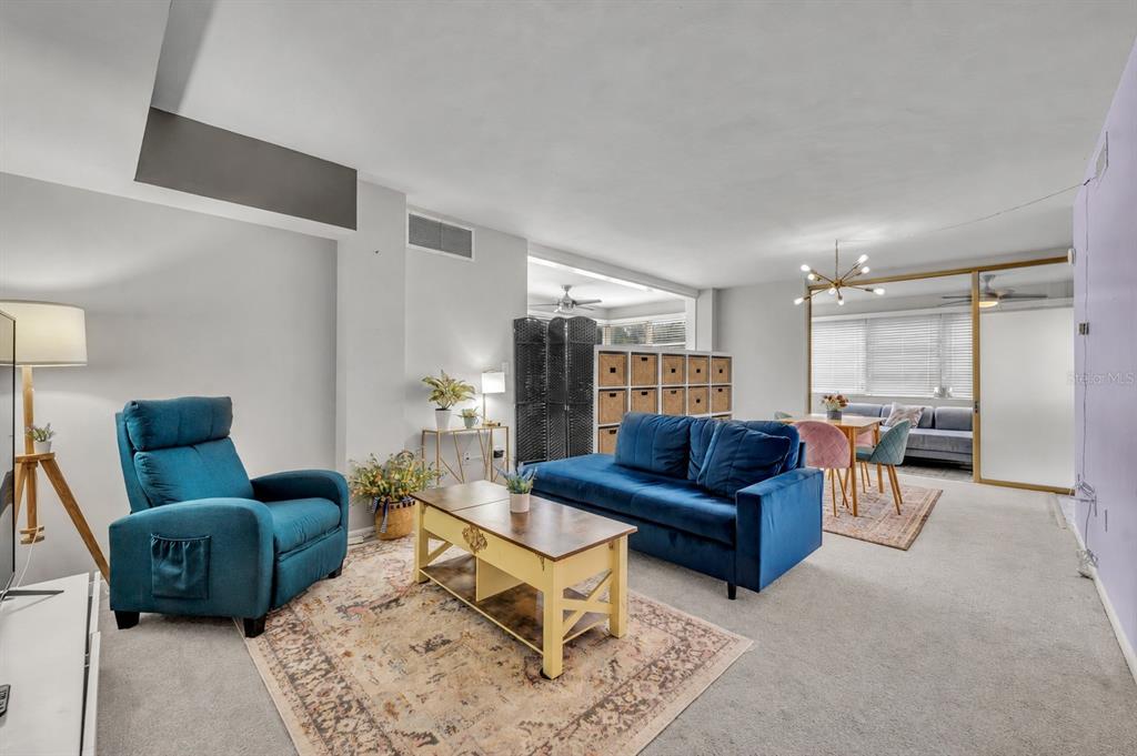 A living room features a blue sofa, a matching recliner, and a wooden coffee table — 311 E MORSE BOULEVARD UNIT 6-12, WINTER PARK, FL