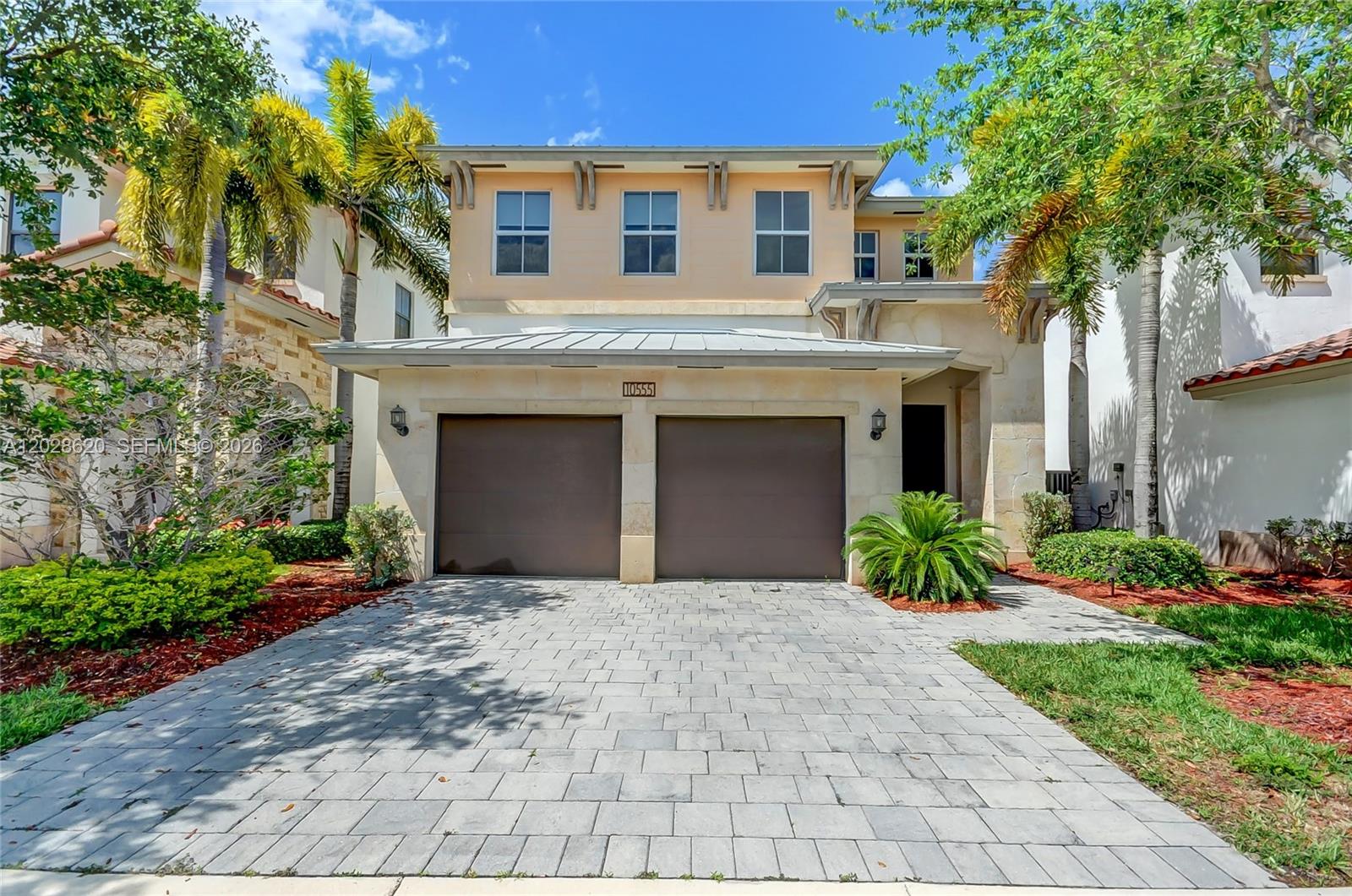 A two-story house features a large wooden pergola covering a patio with outdoor furniture — 10555 NW 69th Ter, Doral FL 33178, DORAL, FL