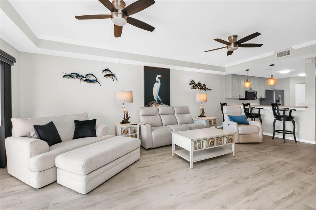 A kitchen features light gray cabinets, stainless steel appliances, and white marble-look countertops — 3322 PURPLE MARTIN DRIVE UNIT 125, PUNTA GORDA, FL