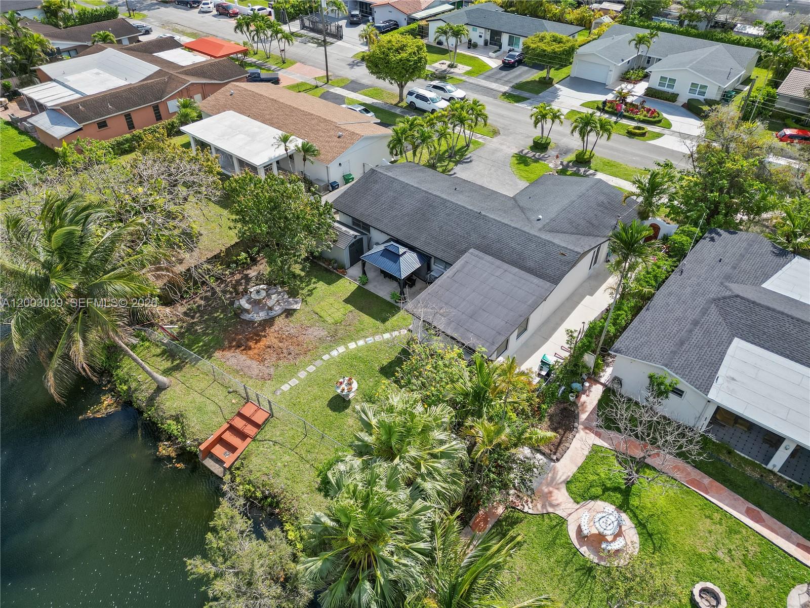 An aerial view shows a residential house with a backyard, patio, and waterfront access — 3921 SW 124th Ct, Miami FL 33175, MIAMI, FL