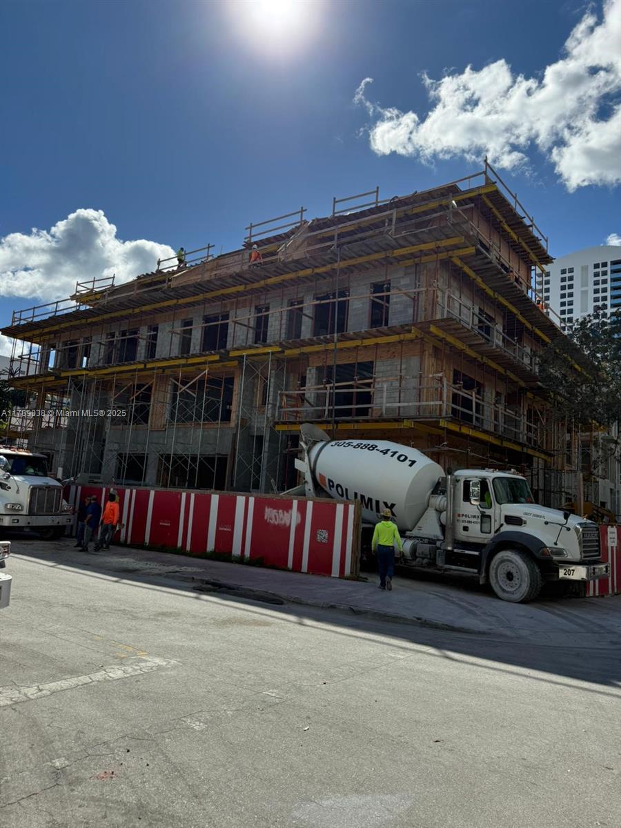 A concrete mixer truck is parked in front of a multi-story building under construction — 1425 Bay Rd, Miami Beach FL 33139, MIAMI BEACH, FL
