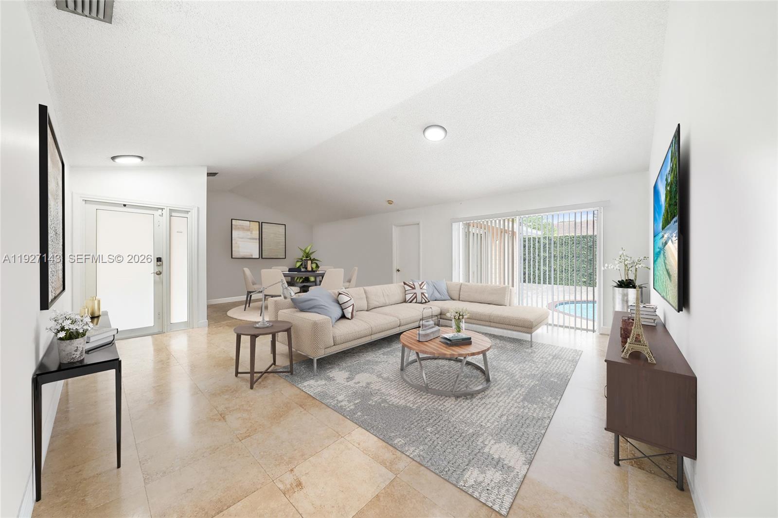 This living room features tile flooring, a sectional sofa, and a sliding door to a pool — 14145 SW 100th Ter, Miami FL 33186, MIAMI, FL