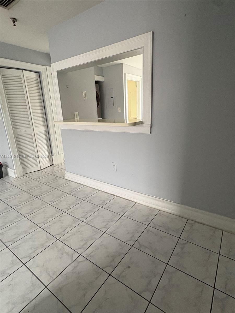 A room with light gray walls, white trim, and white marble-patterned tile flooring — 12035 SW 14th St # 105, Miami FL 33184, MIAMI, FL