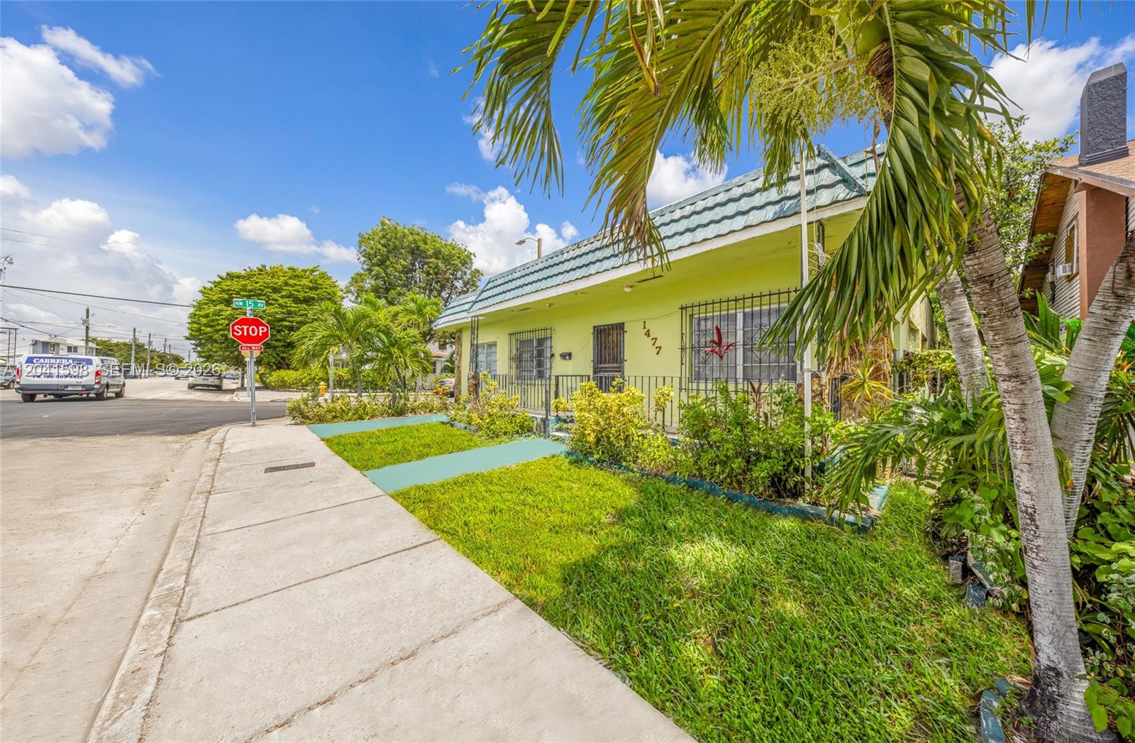 A lime green single-story house with a blue tiled roof sits on a corner lot — 1477 NW 2nd St, Miami FL 33125, MIAMI, FL