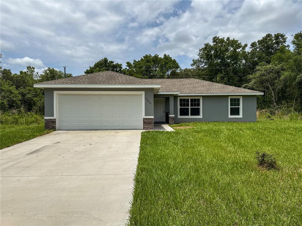 A single-story gray house with a two-car garage and a concrete driveway — 15434 SW 29TH TERRACE ROAD, OCALA, FL
