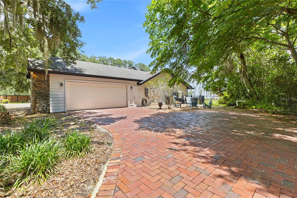 A single-story house with cream siding, stone accents, and a red front door — 10355 TROUT ROAD, ORLANDO, FL