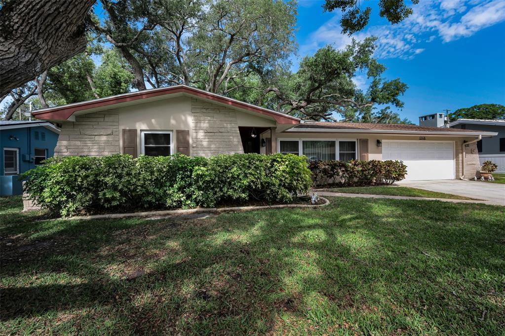 A single-story house with a stone facade, brown trim, and a two-car garage — 1368 WILLIAMS DRIVE, CLEARWATER, FL