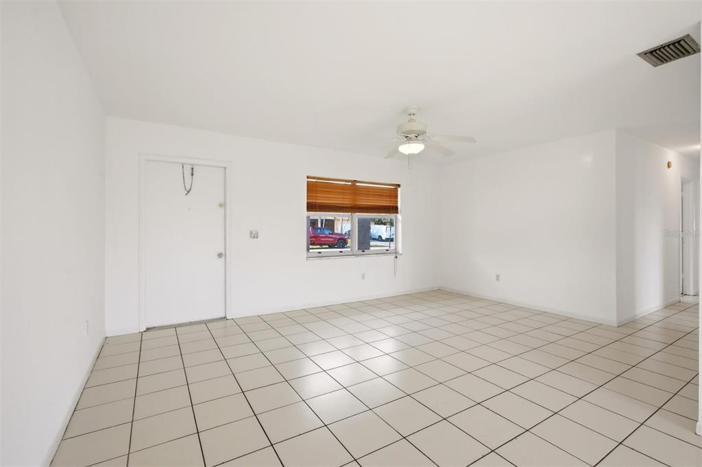 An empty room with white walls, tiled floors, a ceiling fan, and a single window — 10894 GRANITE STREET, BOCA RATON, FL