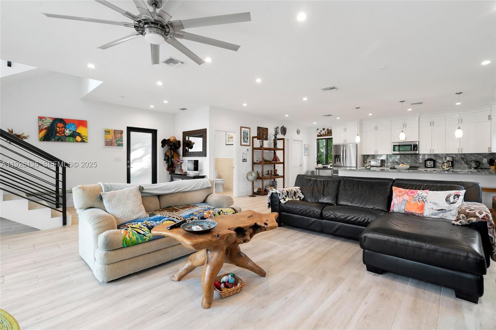A living room with a wooden coffee table, two sofas, and an open-concept kitchen — 669 Colson Dr, Key Largo FL 33037, KEY LARGO, FL