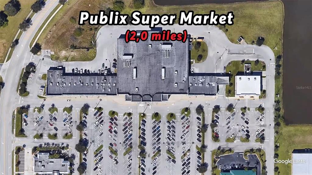 This aerial map view shows a commercial shopping center building with a large parking lot — 328 DADEVILLE STREET SE, PALM BAY, FL
