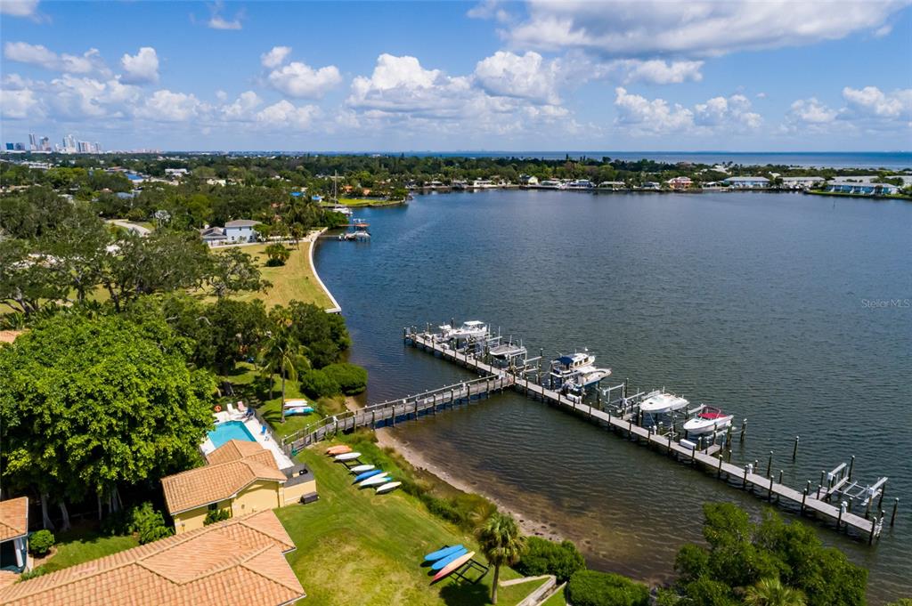 An aerial view shows a waterfront property with a private dock, boats, and a pool — 190 BANYAN BAY DRIVE, ST PETERSBURG, FL