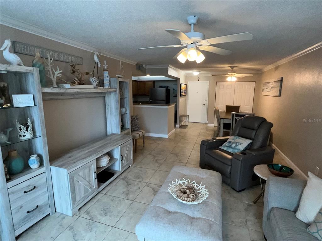 A living room features tile flooring, a ceiling fan, a media console, and a recliner — 2700 COCONUT BAY LN LANE UNIT 4111, SARASOTA, FL