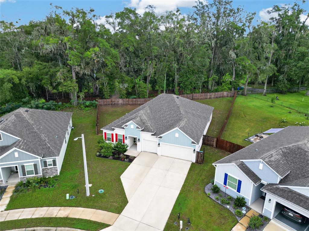 An aerial view shows a single-story house with a two-car garage and a fenced yard — 12377 NW 157TH TERRACE, ALACHUA, FL