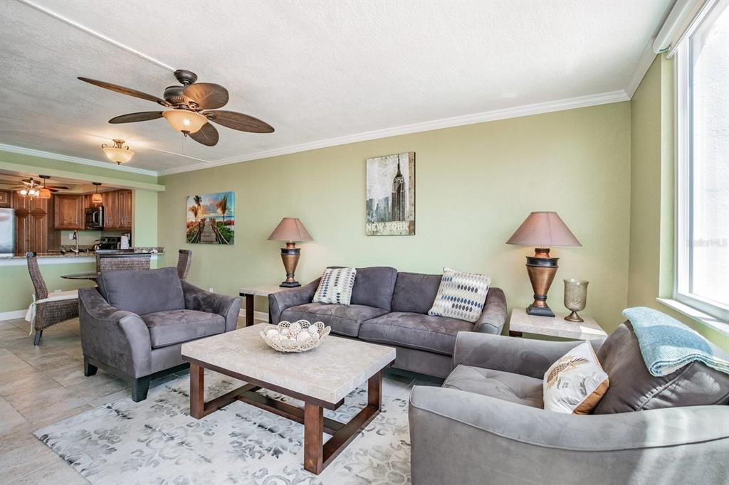 A living room with gray furniture, a stone coffee table, and light green walls — 6295 BAHIA DEL MAR CIRCLE UNIT 401, ST PETERSBURG, FL