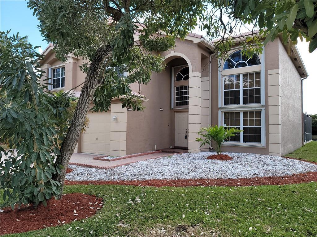 A two-story stucco house with a garage, arched entryway, and white rock landscaping — 2281 SW 164th Avenue, Miramar FL 33027, MIRAMAR, FL
