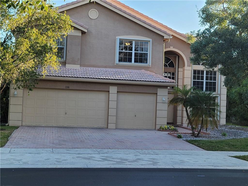 A two-story house with a two-car garage, tile roof, and beige stucco exterior — 2281 SW 164th Avenue, Miramar FL 33027, MIRAMAR, FL