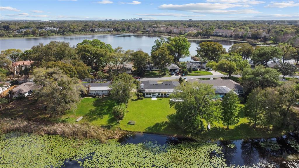 An aerial view shows several houses with large backyards situated along a lakefront — 1501 DRUID ISLE ROAD, MAITLAND, FL