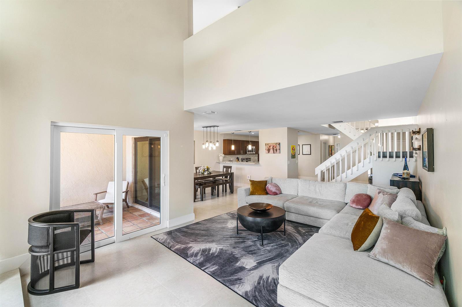 A living room with a sectional sofa, area rug, and sliding doors to a patio — 6044 Glendale Drive, Boca Raton FL 33433, BOCA RATON, FL