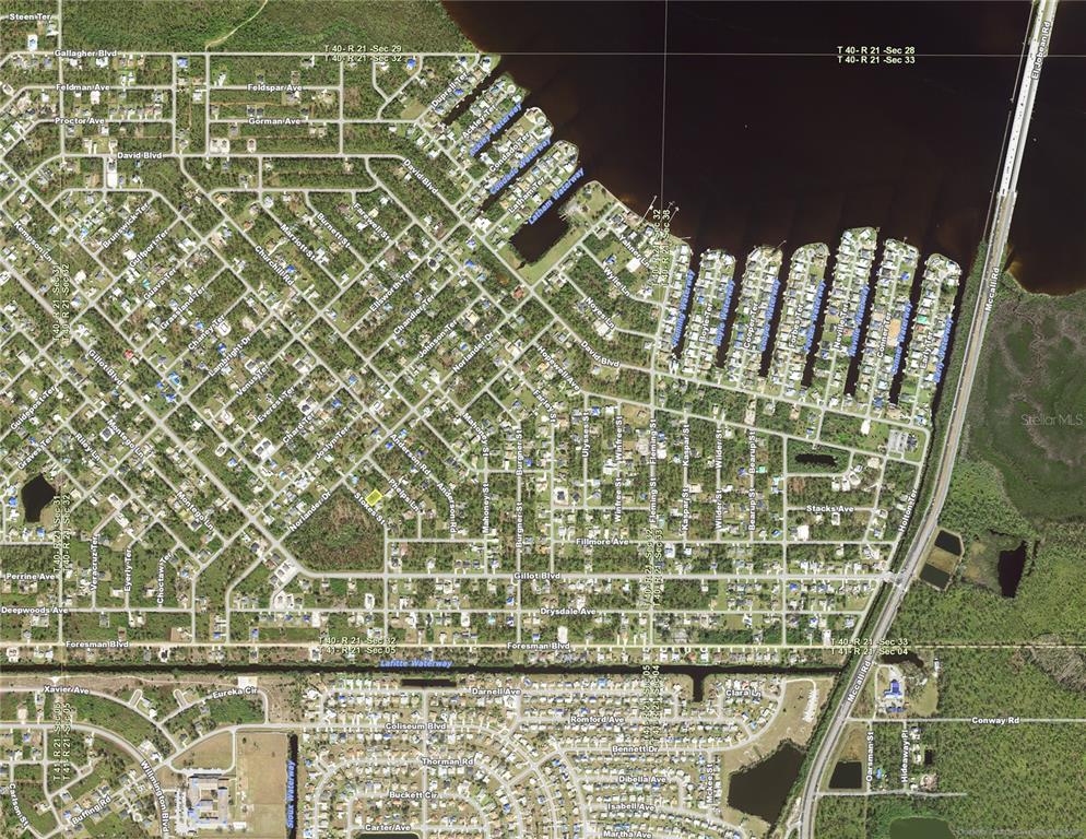 This is an aerial map showing a residential neighborhood with canals and a large bridge — 5410 STOKES STREET, PORT CHARLOTTE, FL