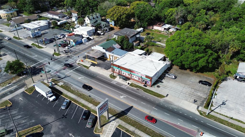 An aerial view shows a commercial building with a parking lot along a busy road — 4408 & 4412 N NEBRASKA AVENUE, TAMPA, FL