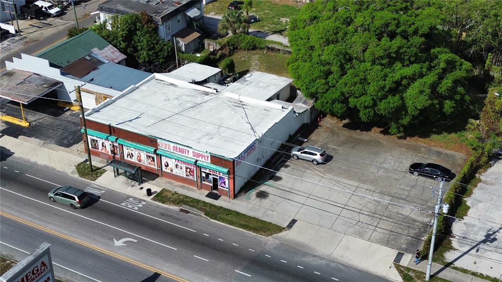 An aerial view shows a commercial building with a parking lot and a large tree — 4408 & 4412 N NEBRASKA AVENUE, TAMPA, FL
