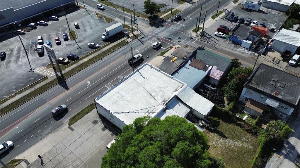 An aerial view shows a commercial building with a flat roof next to a busy road — 4408 & 4412 N NEBRASKA AVENUE, TAMPA, FL