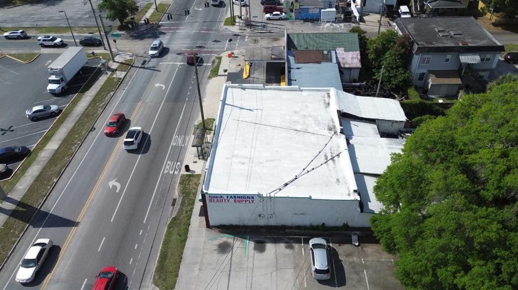 An aerial view shows a commercial building with a white roof next to a road — 4408 & 4412 N NEBRASKA AVENUE, TAMPA, FL