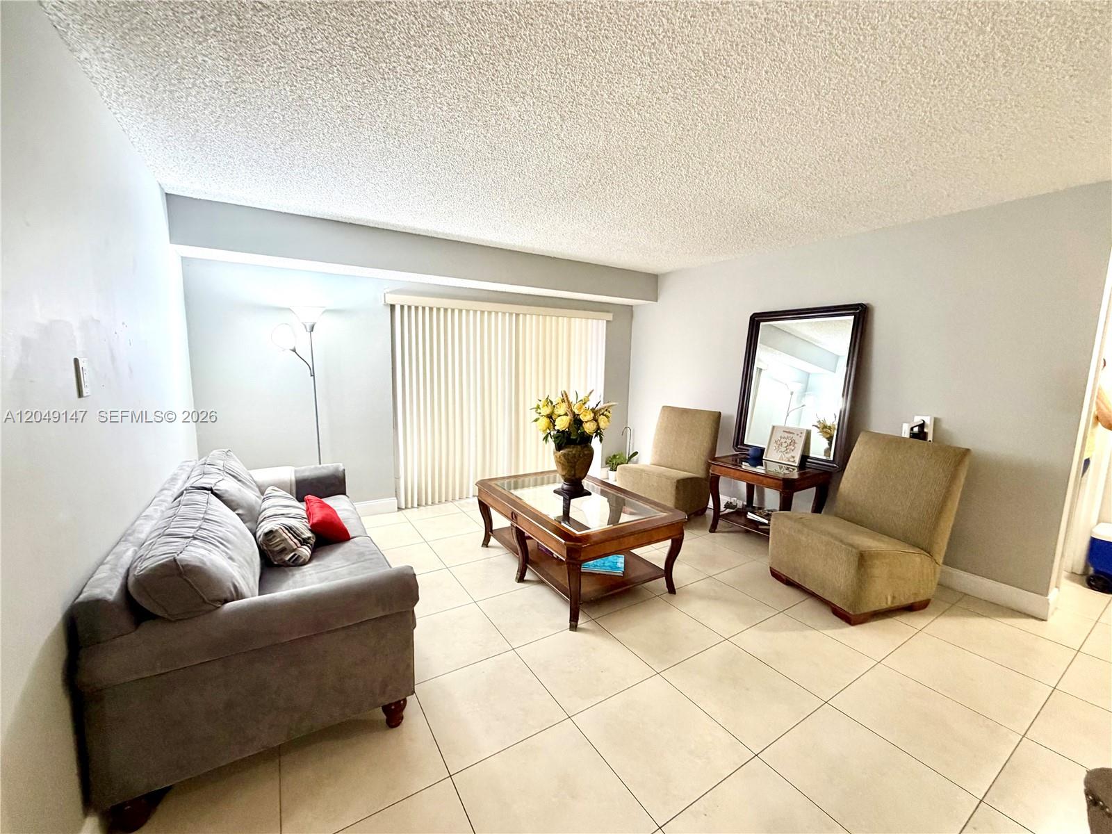 A living room features a gray sofa, two armchairs, a coffee table, and tile flooring — 10521 SW 158th Ct # 203, Miami FL 33196, MIAMI, FL