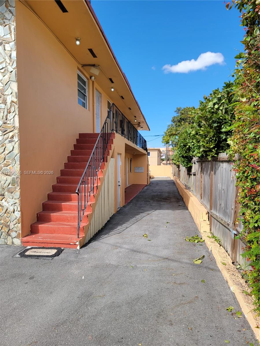 An exterior view shows a peach-colored building with an outdoor staircase leading to a balcony — 1753 SW 6th St, Miami FL 33135, MIAMI, FL