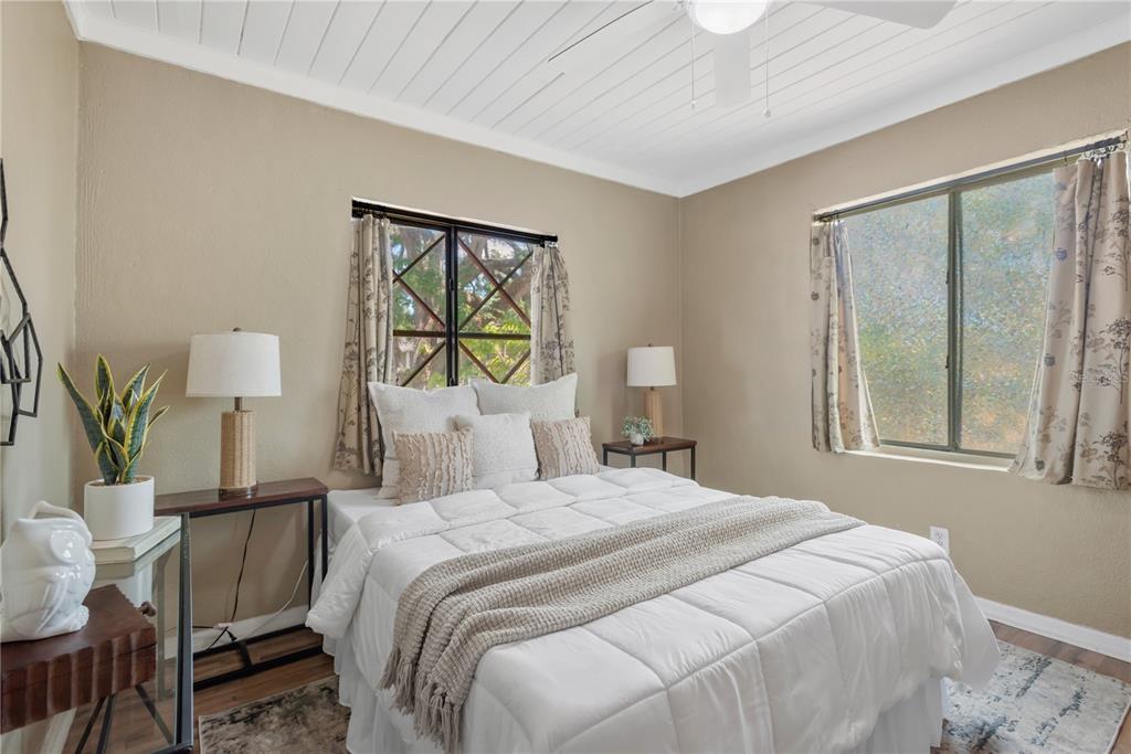 A bedroom features a white bed, two windows, and a white plank ceiling — 1315 E OSBORNE AVENUE, TAMPA, FL