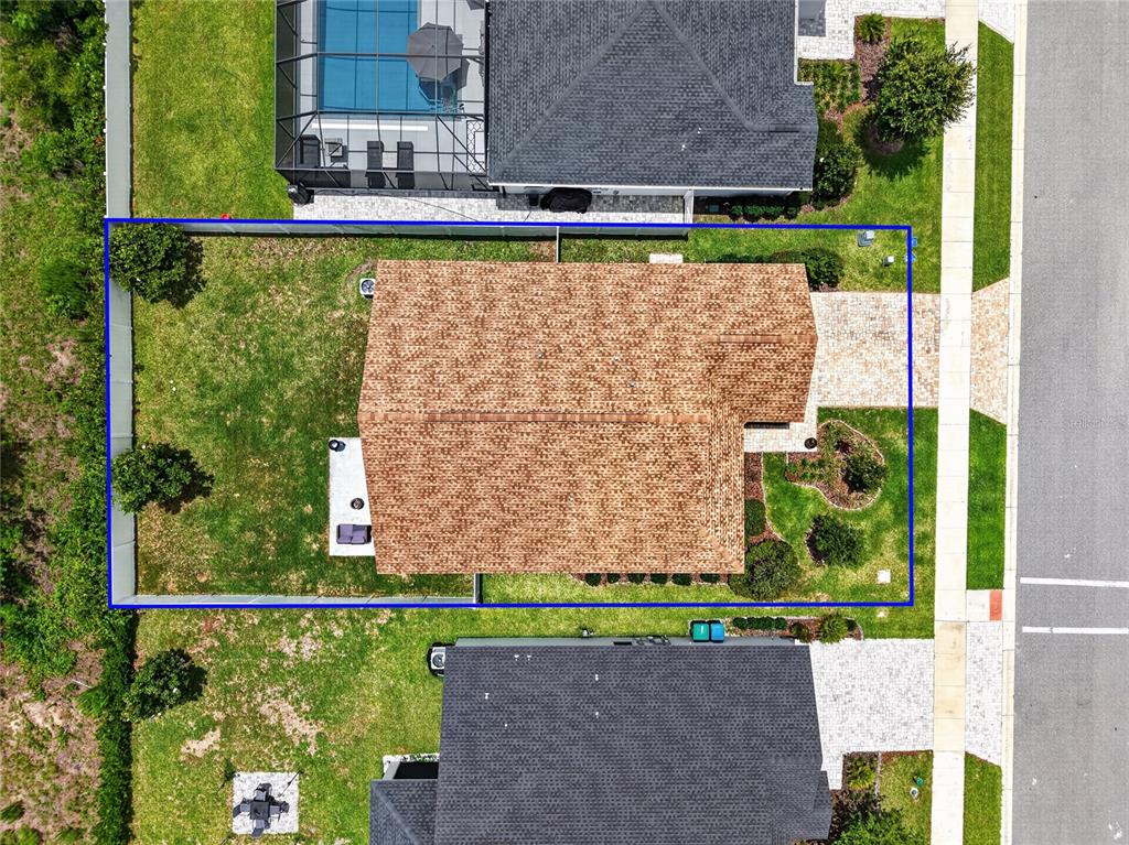 An aerial view shows a single-family home with a fenced backyard and a paved driveway — 12591 NE 49TH DRIVE, OXFORD, FL