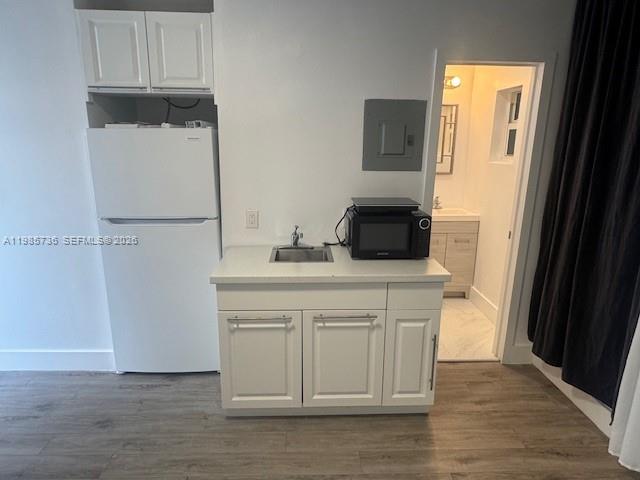 A small kitchen area features a white refrigerator, a sink cabinet, and a microwave — 9920 Collins Ave # 23, Bal Harbour FL 33154, BAL HARBOUR, FL