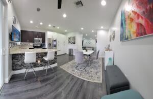 A living room features a grey sectional sofa, a blue area rug, and wall art — 6960 Long Pine Circle, Coconut Creek FL 33073, COCONUT CREEK, FL