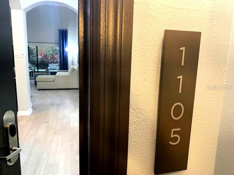 A view from a doorway into a living room with light flooring and a sofa — 14501 GROVE RESORT AVENUE UNIT 1105, WINTER GARDEN, FL