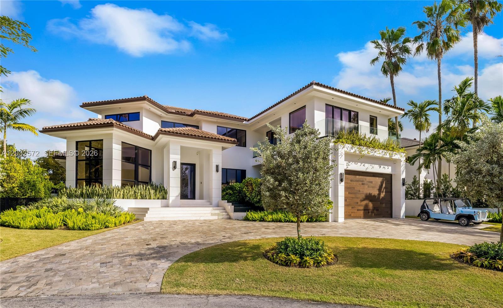 A modern two-story white house with a tiled roof, paved driveway, and a golf cart — 199 Caoba Ct, Coral Gables FL 33143, CORAL GABLES, FL