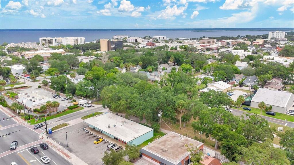 An aerial view shows a commercial building with a parking lot near a residential area — 00 LAUREL AVENUE, SANFORD, FL