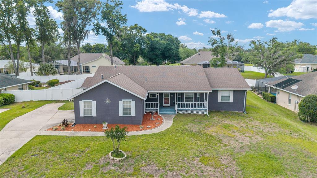 An aerial view of a single-story gray house with a brown shingled roof and porch — 4807 SE 14TH STREET, OCALA, FL