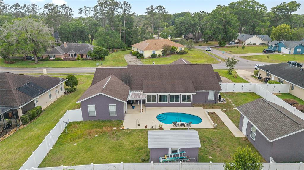 An aerial view of a house with a swimming pool, a shed, and a fenced yard — 4807 SE 14TH STREET, OCALA, FL