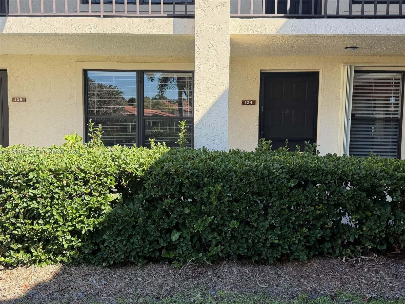 A view of the exterior of a building showing unit numbers 104 and 105 — 301 SW South River Dr # 104, Stuart FL 34997, STUART, FL