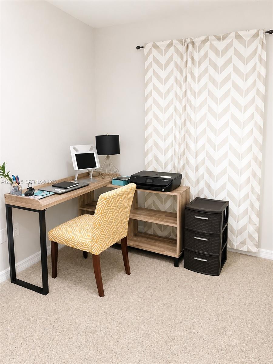 A home office features an L-shaped wooden desk, a patterned chair, and a black printer — 3327 Columbia Square Way, Fort Pierce FL 34982, FORT PIERCE, FL