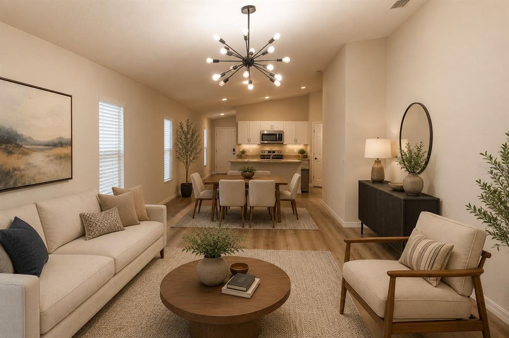 A living room and dining area with light wood floors, neutral furniture, and a chandelier — 1341 DERRY AVENUE, HAINES CITY, FL