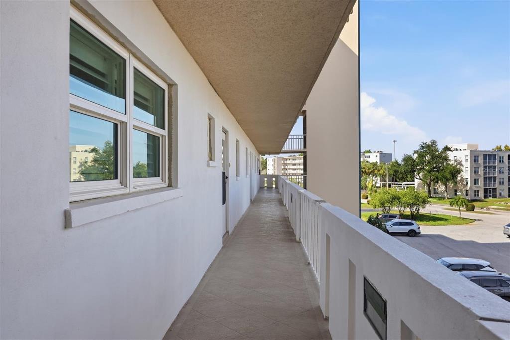 An outdoor apartment balcony with white walls, a tiled floor, and a metal railing — 4040 IRONWOOD CIRCLE UNIT 304F, BRADENTON, FL